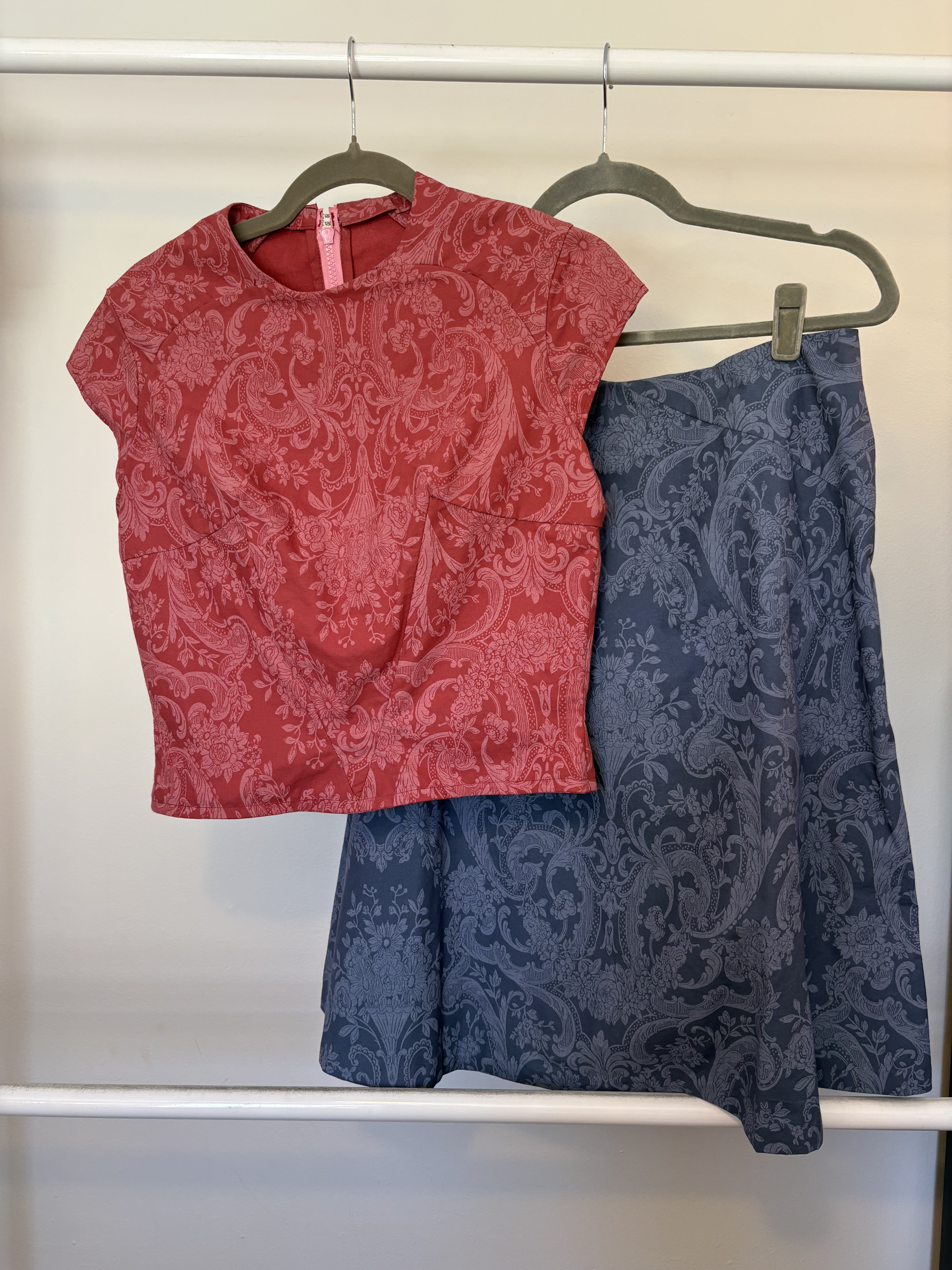 Red paisley top and navy skirt on the rail